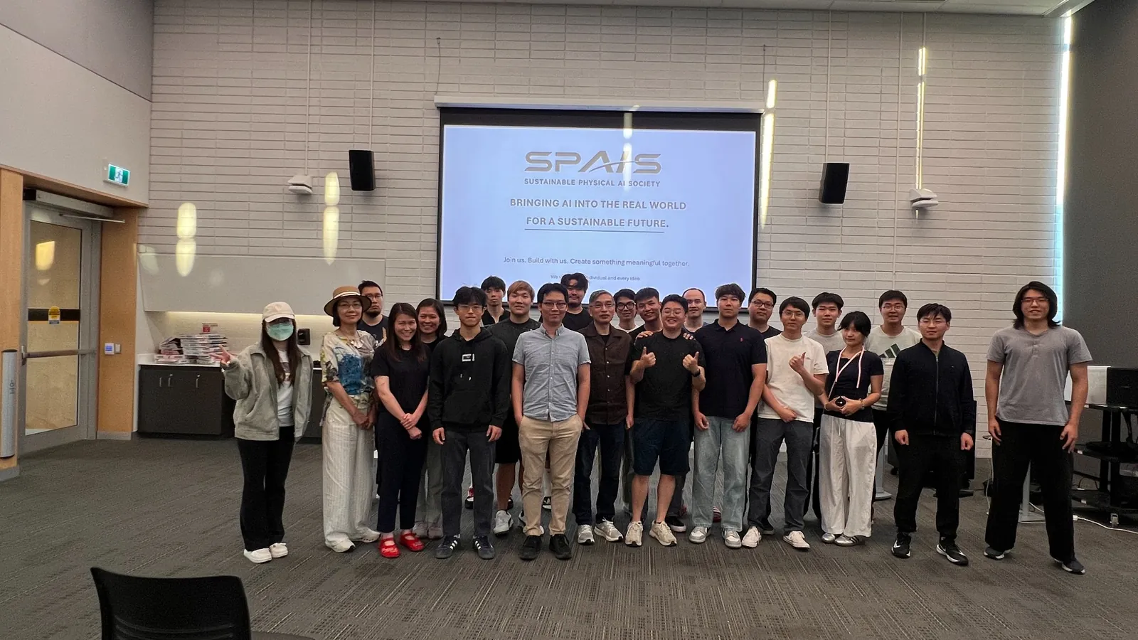 The SPAIS community together in front of the society’s presentation screen.